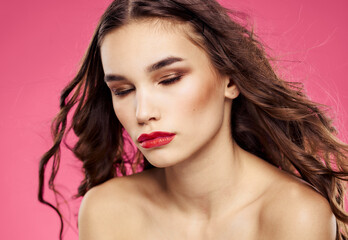 Pink background female portrait bared shoulders red lips