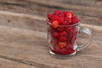 raspberries in a cup
wood background