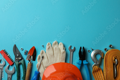Concept of Labor Day with different tools on blue background