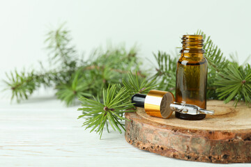 Aromatherapy concept with pine oil on white wooden table
