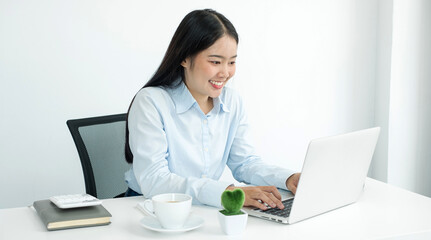 Asian woman working laptop. Successful smiling businesswoman sitting working at the office