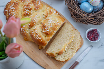 Sweet home made braided yeast bun for easter on a table