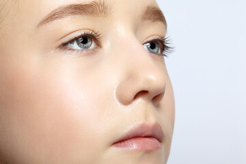 Obraz premium Closeup shot of human teenager girl face. Young female with natural face and eyes beauty makeup