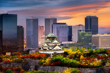 Fototapeta premium Osaka castle stay in the middle of the develops city in the season change of autumn, upcoming sport event in Japan, visit and travel in Japan, Sport Event, Travel Japan