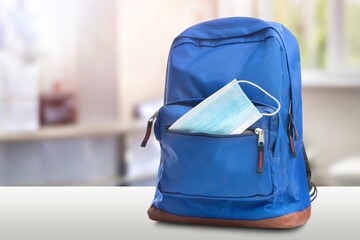 Classic school backpack with colorful school supplies and books