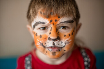 little boy with tiger face painting