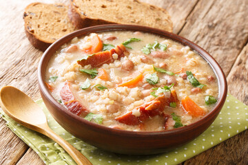 Slovenian Meat and Vegetable Barley Soup Ricet close-up in a bowl on the table. horizontal