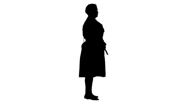 Silhouette Middle-aged woman in trench standing.