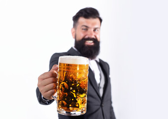 Man hand hold cup glass of beer, selective focus. The celebration oktoberfest festival concept. Beer concept. Bearded man drink beer.