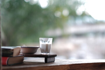 Glass for milk and snacks on a wooden table
