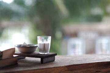Glass for milk and snacks on a wooden table