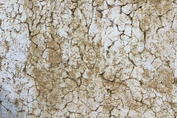 White Dirty Cracked Texture Background of Old Barn Clay Wall covered with Lime