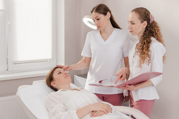 Fototapeta premium Two doctors examining a patient