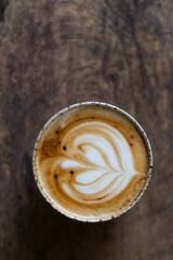 close up view  preparing a coffee by drawing a flower with milk