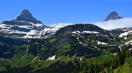 Fototapeta na wymiar spectacular reynolds and clements mountains, waterfalls, and glacial valley in early summer along the going-to-the-sun road in glacier national park, montana