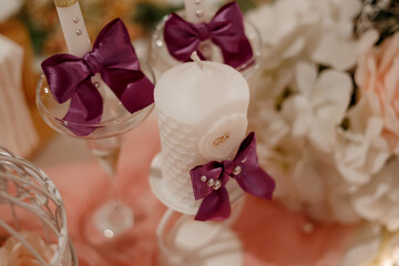 white candles decorated with ribbons