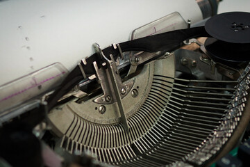 Isolated vintage typewriter keyboard. Slow dolly across type writer keys. Macro shot of retro typewriter keys. typewriter and novel book on table. Romantic macro shot. Underwood typewriter