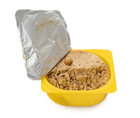 Peanut halva in yellow plastic box isolated on white background.
