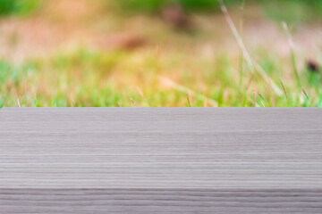 Fototapeta premium Empty wood table shelf and blurred grass nature background. Product display template. Business presentation concept.