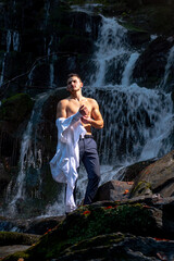 businessman undressing at waterfall ready to swim. business trip. summer vacation traveling. agile business. agine methodoly. Money waterfall and businessman. River of cash. relax of everyday life.