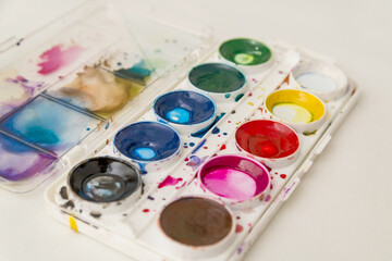 a set of used old watercolors. a box of watercolors for drawing, a palette. The concept of the...