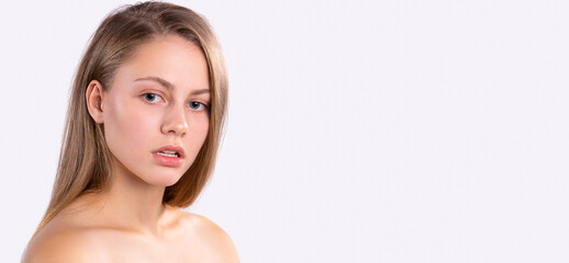 Naklejka premium Banner,long format. Beauty portrait of a young blonde girl with clean and fresh skin, with natural makeup. Side advertising space. White background.