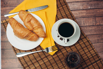 croissants saucer on the table fork with a knife fresh pastries dessert morning