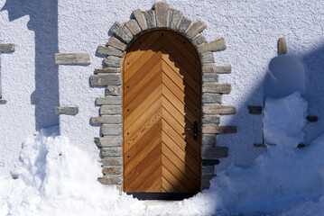 Beautiful wooden door of roman catholic chapel at mountain Gornergrat, Zermatt, Switzerland. Photo...