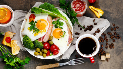 Fried eggs with vegetables on dark grey background