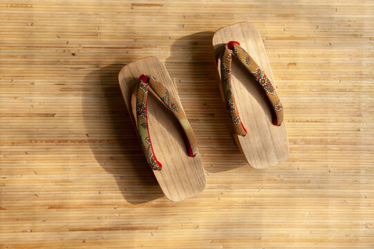 Wooden geta flipflops on tatami mat

