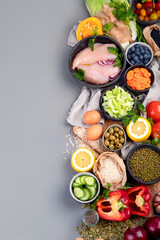 Selection of organic raw healthy products on gray background product.