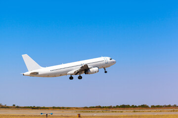 Fototapeta na wymiar Passenger plane takes off from runway in airport