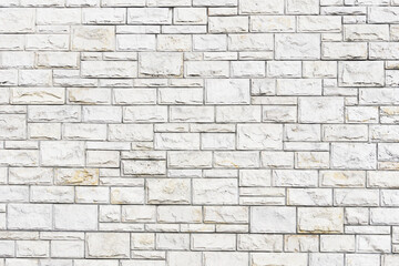 White paint brick wall background. Outdoor house facade texture. Gray vintage block structure. Old architecture background.