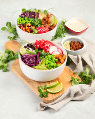 Tasty colorful vegan poke bowl on light gray background.