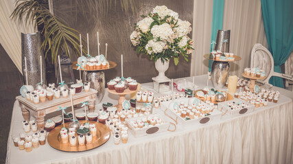 Wedding table decoration with flowers and snacks