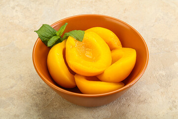 Sweet ripe canned peaches with mint