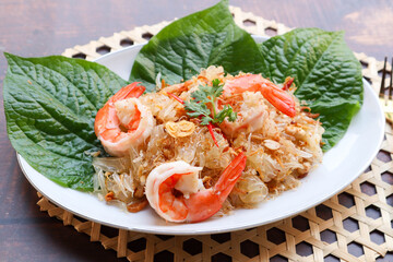 Pomelo Salad with shrimp - In Thai food called Yum Som O (Thai food at close up view on wood table)