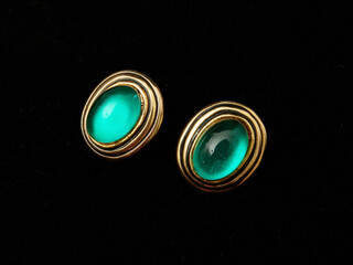 Golden vintage earrings from the eighties with gems inlaid on them