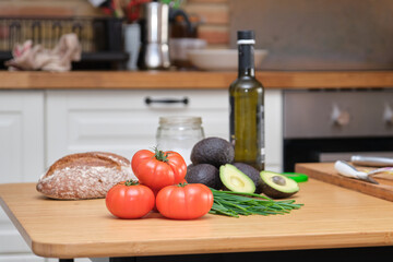 Tomatoes, avocados, bread, olive oil and chive. Mediterranean diet ingredients.