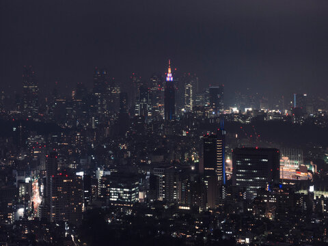 Illuminated cityscape buildings at night, Tokyo, Japan
