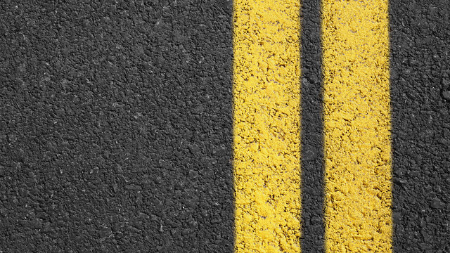 Surface grunge rough of asphalt, Grey with double yellow line on the road and small rock, Texture Background, Top view, Close up