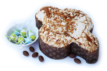 Sweet Easter cake called Colomba Pasquale on white with  chocolate eggs. Italian traditional pastry 