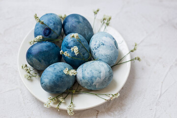 Close-up of blue painted traditional eggs for Easter holiday on grey background. Selective focus