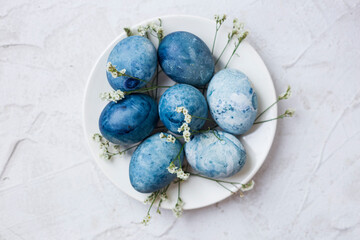 Close-up of blue painted traditional eggs for Easter holiday on grey background. Selective focus