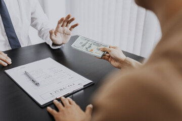 Business people giving a bribe of money at contract, Corruption concept..