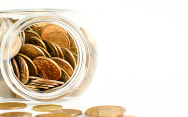 Glass jar fell and metal money crumbled, isolated on white background. Store personal savings. Copy space. Selective focus.