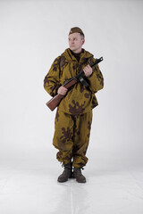 Actor man in an old military uniform and camouflage sniper marksman clothing of a soldier of the...