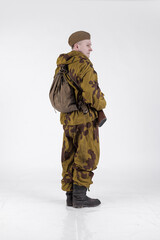 Actor man in an old military uniform and camouflage sniper marksman clothing of a soldier of the...