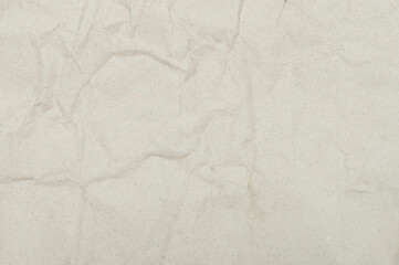 Empty crumpled beige color paper surface
