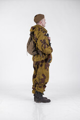 Actor man in an old military uniform and camouflage sniper marksman clothing of a soldier of the...